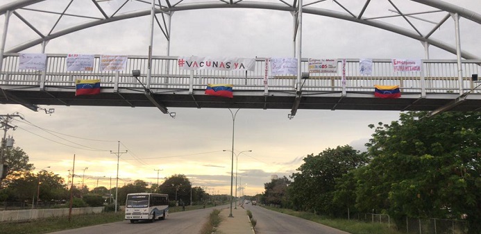 Colocan carteles para exigir vacunación contra COVID-19 en la pasarela de Tía Juana